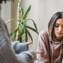 sad teen girl sitting talking to an adult
